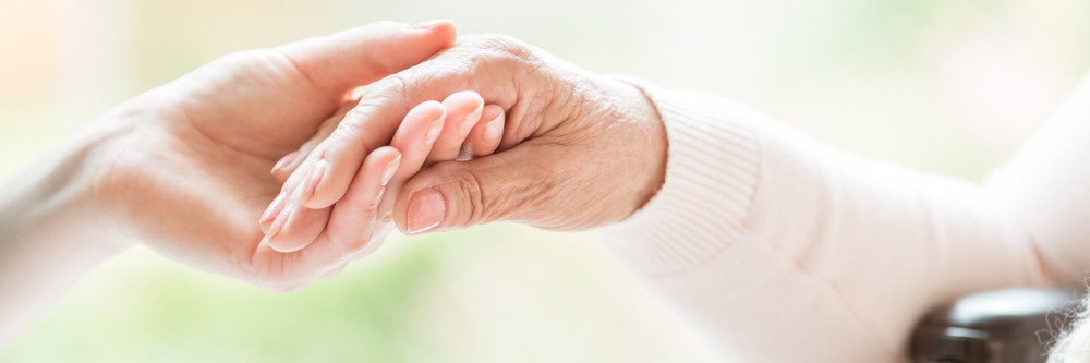 Young hand holding senior hand caring gesture