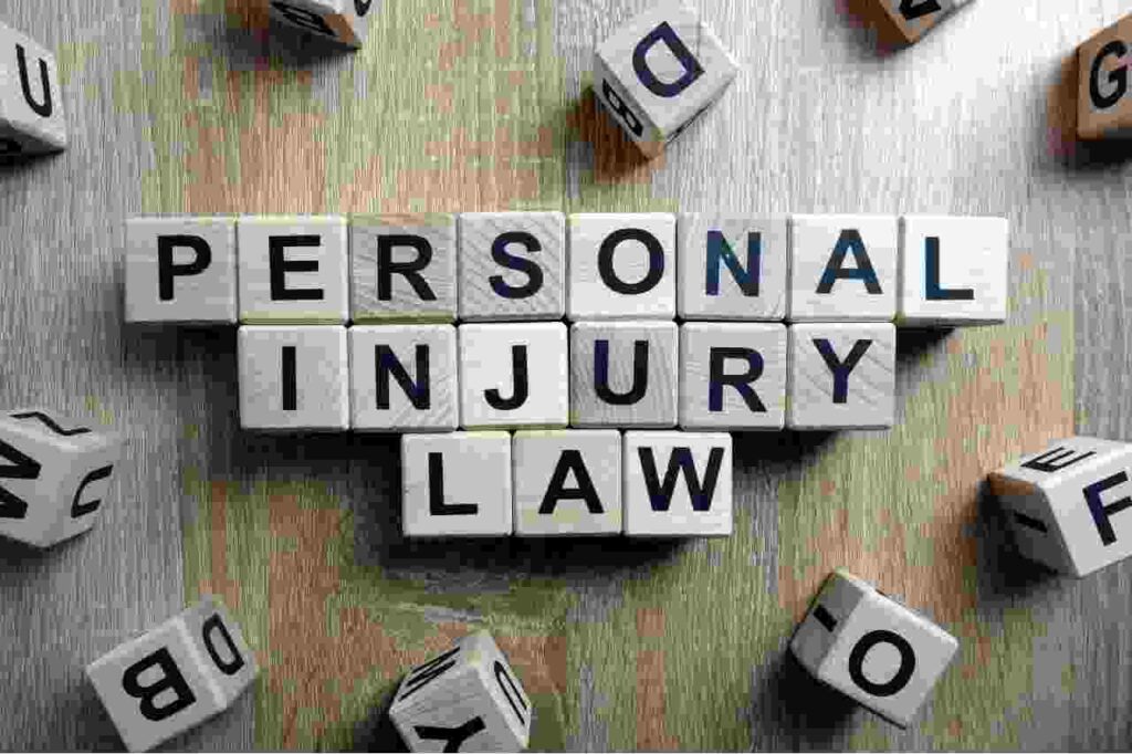 Words personal injury law spelled in black writing text on wooden blocks on table