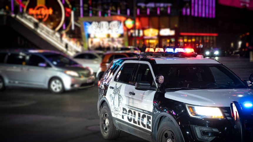 Police car in foreground Las Vegas at night in background car accident silver orange vehicles