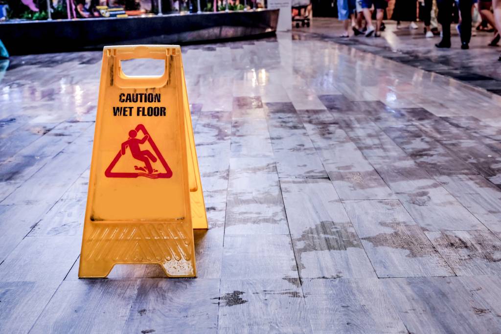 Caution wet floor sign on marble flooring in sophisticated building