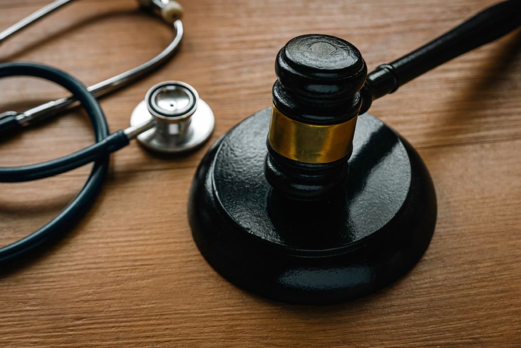 Judge’s gavel and stethoscope on wooden table for civil personal injury claim