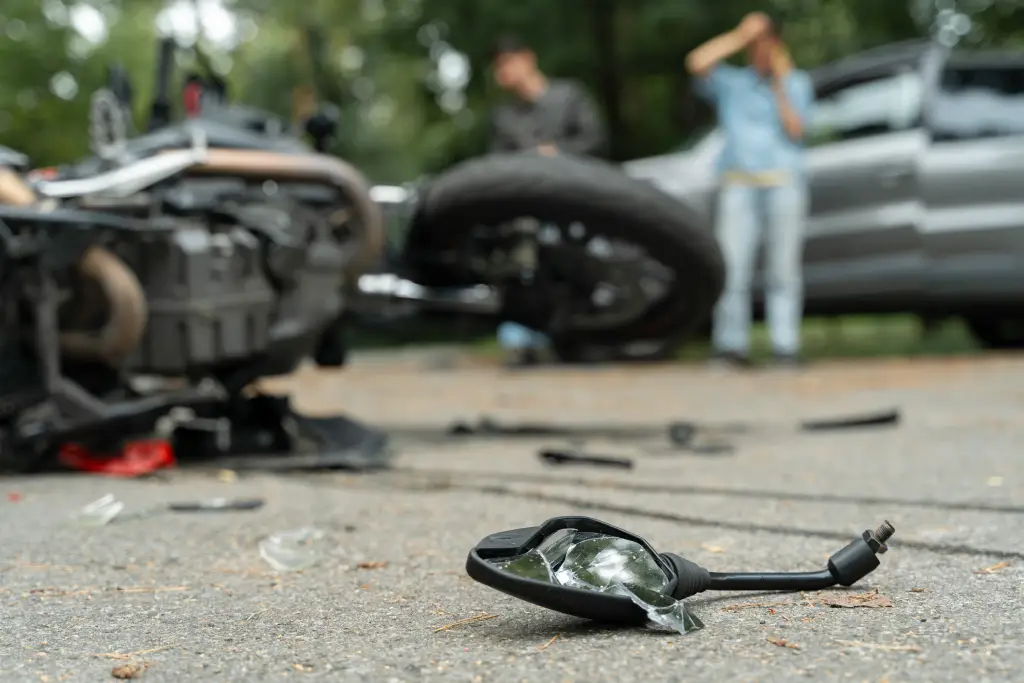 A wrecked motorcycle in a soft-focus photo after an accident.